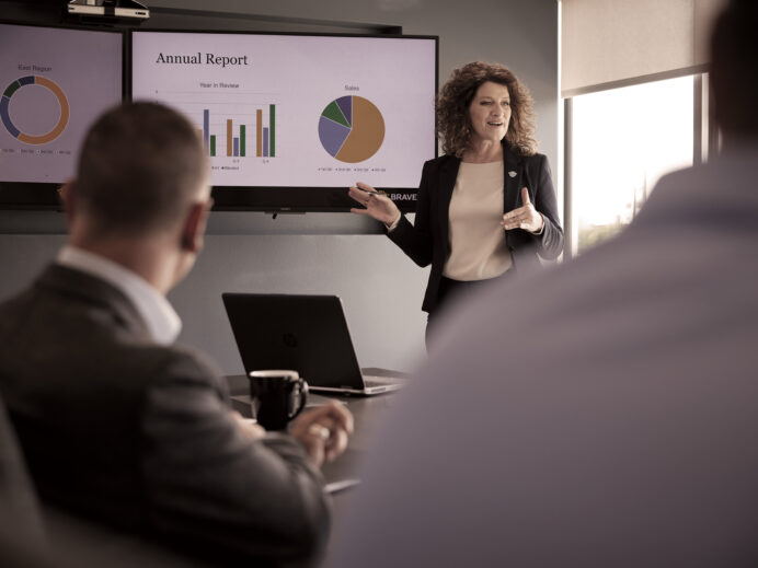 An image from Bravera marketing collateral of a woman leading a meeting
