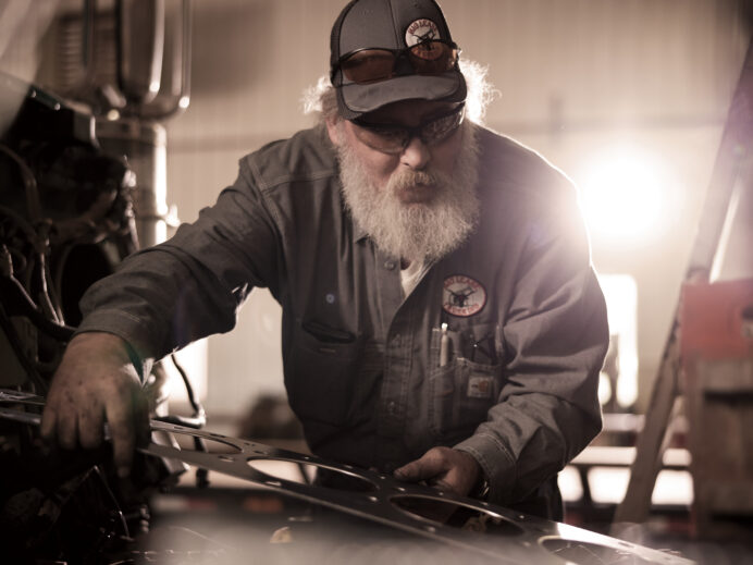 An image from Bravera marketing collateral of a man wearing coveralls working