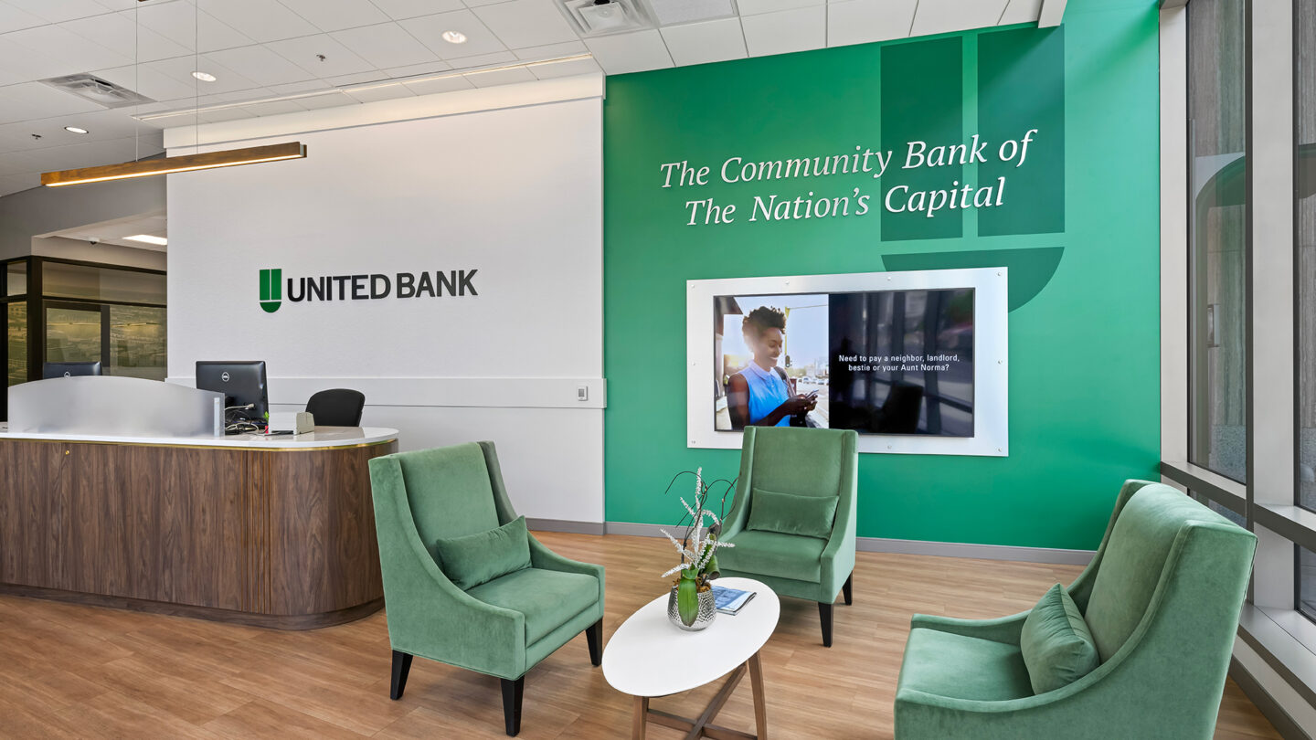 Inside a United Bank branch lobby with digital screen and consultative area